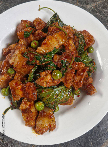 Stir-fried pork belly with curry paste. Pork belly stir-fried with curry paste. Thai food. Spicy. Pork with herbs. Thai food. Pork. Spices. Herbs   