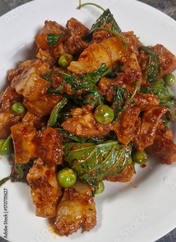 Stir-fried pork belly with curry paste. Pork belly stir-fried with curry paste. Thai food. Spicy. Pork with herbs. Thai food. Pork. Spices. Herbs   