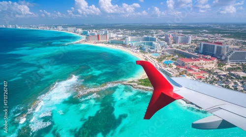 Looking out the plane window, you can see the wing. Below is the Mexican coast with Cancun's hotels in Quintana Roo.
