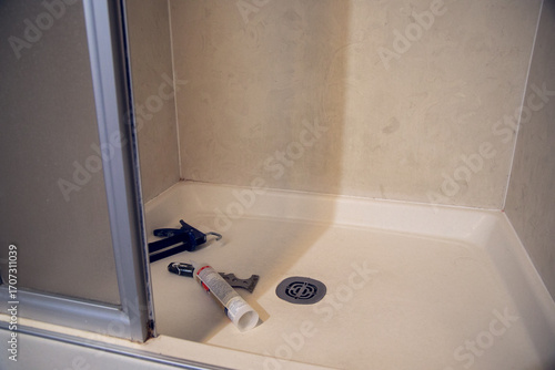 Tools to recaulk a bathroom shower with peeling grout and missing tile