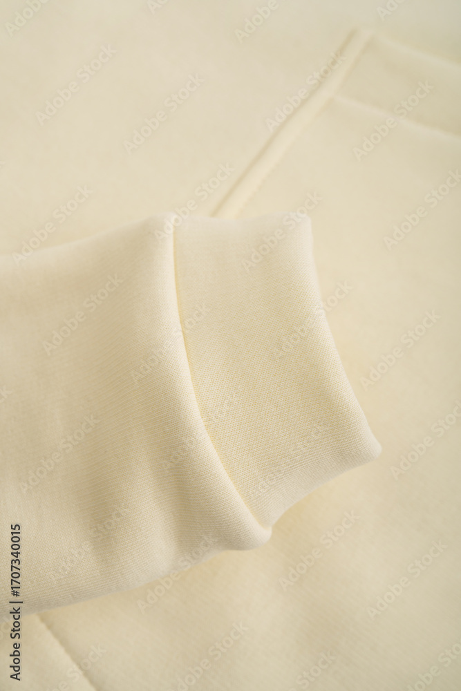 Obraz premium Hoodie texture. Close-up of the sleeve of a yellow hoodie. Cotton. Warm textile fabric, macro.