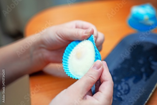 Wallpaper Mural Child's hands carefully removing a perfectly cooked poached egg from a silicone pod form in a kitchen setting Torontodigital.ca