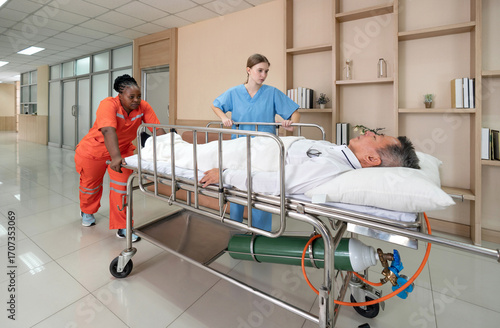 Two healthcare worker are hurriedly transferring a patient on a stretcher in a  well-lit hospital hallway during the day, illustrating urgency and teamwork in medical care.