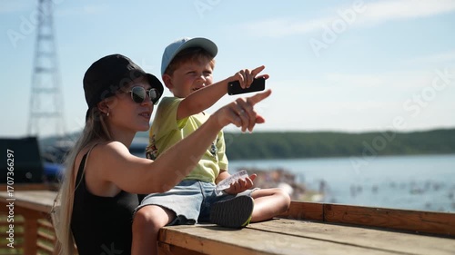 A young mother shows her child with a sign where they will go next