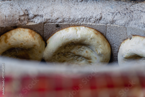 Photos Uzbek flatbread whist on hay of tandoor and get ready