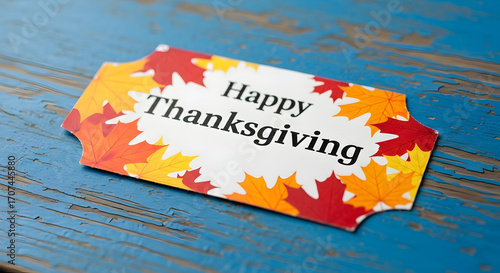 Festive Thanksgiving greeting card featuring colorful autumn leaves on a rustic blue wooden surface