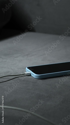 A connected cable charges a dead battery on a smartphone.
Phone charger.
Smartphone, phone, charging, battery