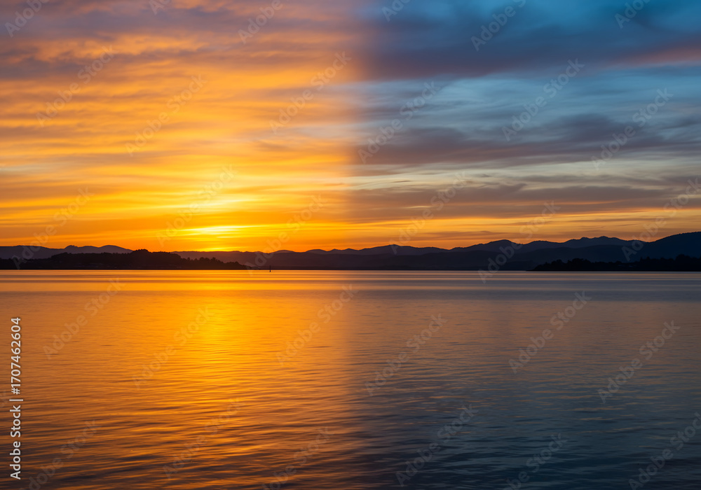 Fototapeta premium Dramatic Evening Sky over Blue Water, Scenic Seascape Background