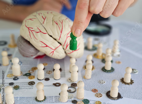 Creative minds at work exploring cognitive functions with brain models and wooden figures concept