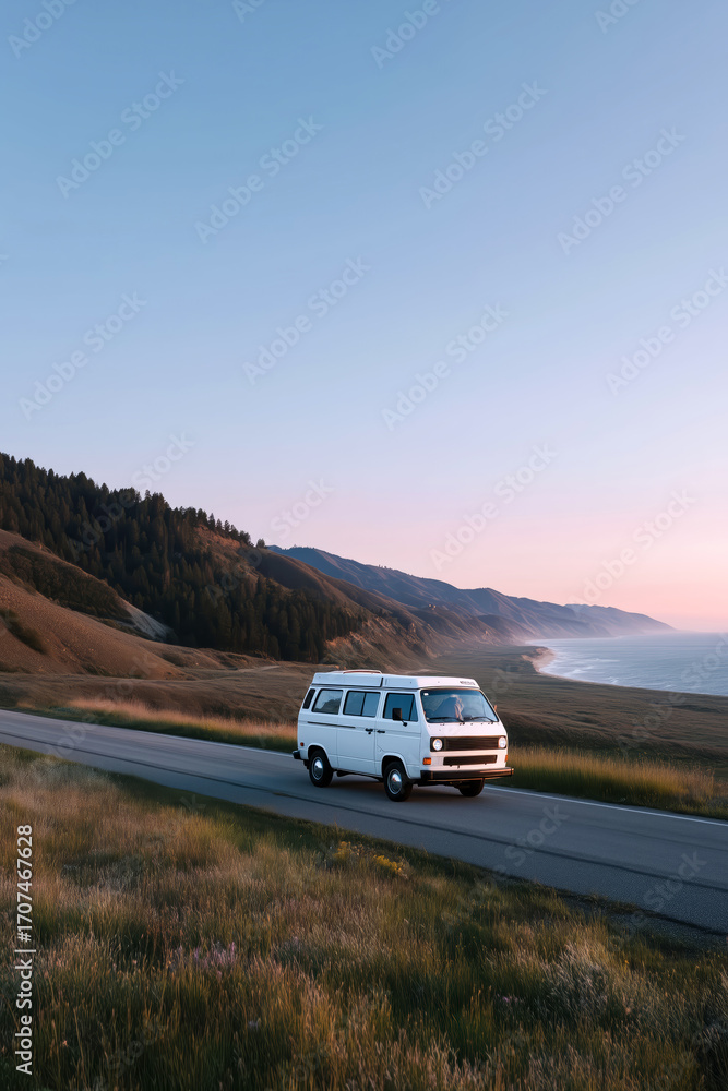 Obraz premium Vintage camper van road trip adventure on scenic coastal highway at sunset
