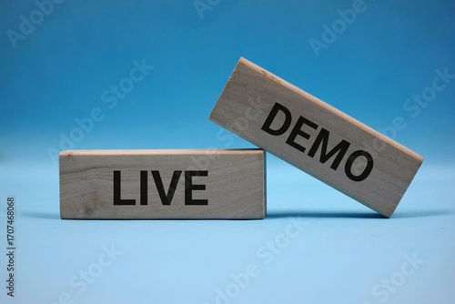 Two wooden blocks with black text spelling 'Live Demo', placed on a blue background emphasizing simplicity and clarity.