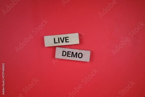 Two wooden blocks with black text spelling 'Live Demo', placed on a red background emphasizing simplicity and clarity.
