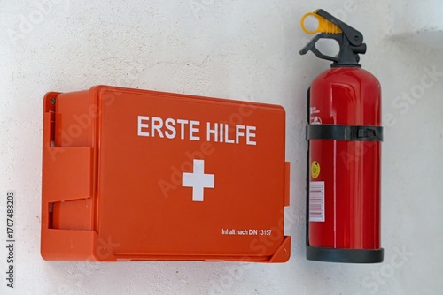 First aid box and fire extinguisher on wall