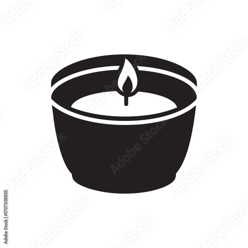 Silhouette of a small candle inside a cup. The candle is low and round with a small flame. 