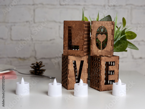 Wooden candlesticks in the form of the word Love