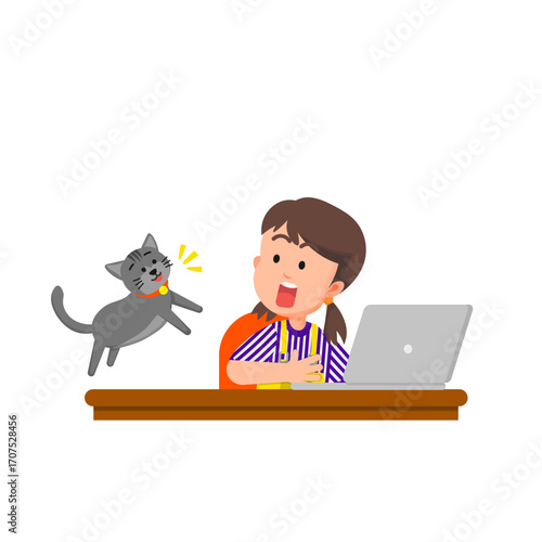 A little girl at her study desk surprised by her jumping cat