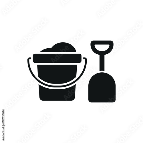 Bucket and spade with sand icon in glyph for simple summer and holiday graphics.