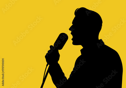 A silhouette of a man singing into a vintage microphone against a yellow backdrop