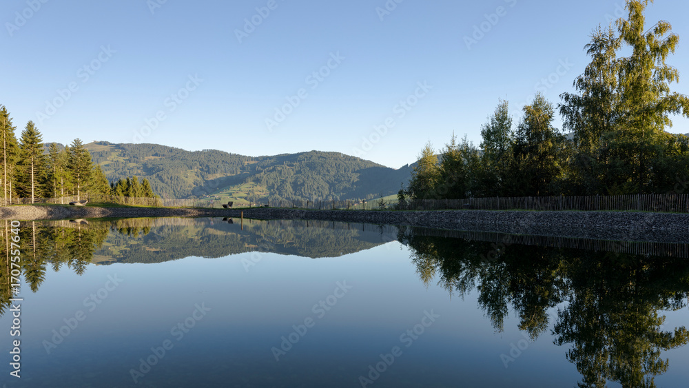Obraz premium Calm Alpine Pond with Reflections in Tyrol, Austria
