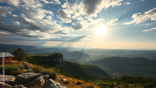 Beautiful rays of sun shine through the clouds over a vast mountain landscape, creating a dramatic and hopeful scene.
