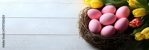 Colorful Easter eggs placed in a nest surrounded by vibrant flowers on a white wooden surface