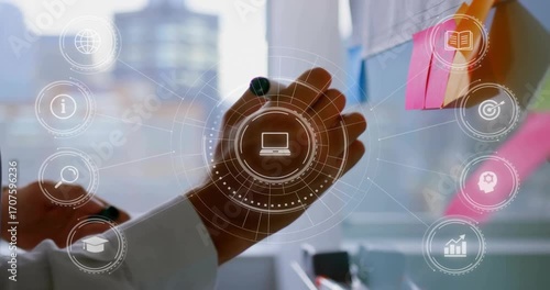 Businessman pressing pink sticky note on glass, activating laptop, analytics icons organizing ideas