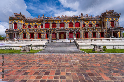 Wallpaper Mural A beautifully restored Kien Trung Palace in Hue, with its vibrant yellow facade, striking red windows, and elaborate rooftop decorations under a cloudy sky. Torontodigital.ca