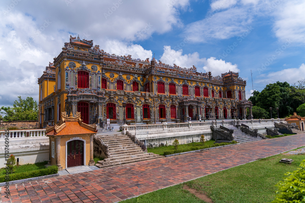 custom made wallpaper toronto digitalThe magnificent, recently restored Kien Trung Palace in Hue, showcasing a vibrant yellow facade, striking red windows, and highly intricate architectural details under a cloudy sky.