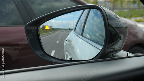 The blind zone sensor signal lights up in the car mirror when another car overtakes it
