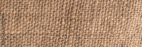 Jute hessian sackcloth woven organic burlap, hemp flax texture pattern background in light cream yellow beige brown color. Texture of burlap
