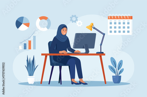 Muslim woman in hijab works at desktop in modern office surrounded by plants and clocks, charts, calendar. Business planning and analytics. Productivity concept. Remote work