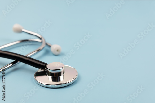 Close up of stethoscope on blue background medical concept