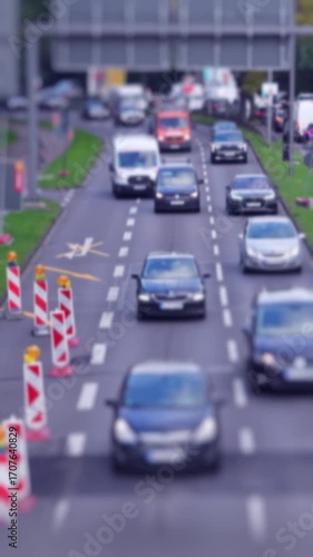 Urban traffic building site, congestion, cars driving towards camera, close