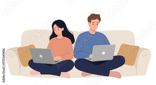 A young couple, a man and a woman, sit back-to-back on a couch, each focused on working or studying on their own laptop computer.