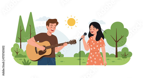 A young man plays an acoustic guitar while a woman sings into a microphone in a sunny park.