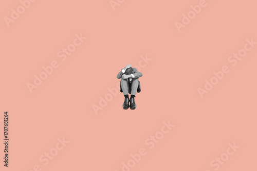 sad businessman curled up in the floor