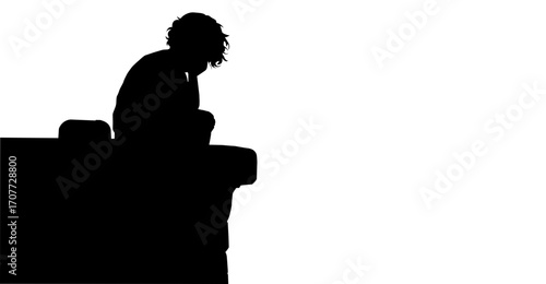 Silhouette of a Depressed Person Sitting on a ledge