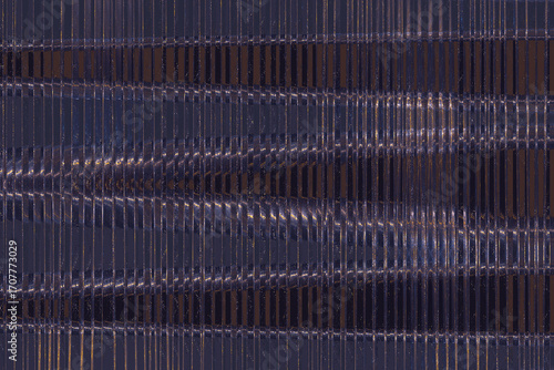 Closeup of an air conditioning units condenser coil showing the fins