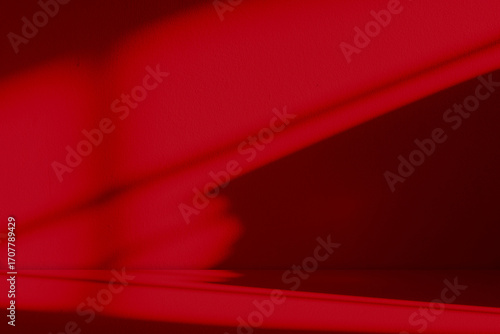 Abstract red background with shadow light effect on wall studio interior for product display Chinese New Year celebration, Christmas theme,Valentine’s Day design,festive decoration,modern marketing
