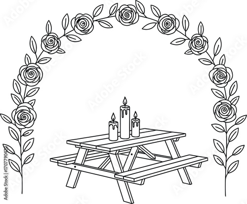 Romantic picnic table adorned with floral arch and glowing candles for an intimate outdoor celebration.