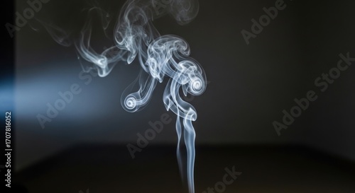 Wisps of light-illuminated smoke curl upwards, displaying ethereal textures against a dark backdrop, creating dynamic abstract art