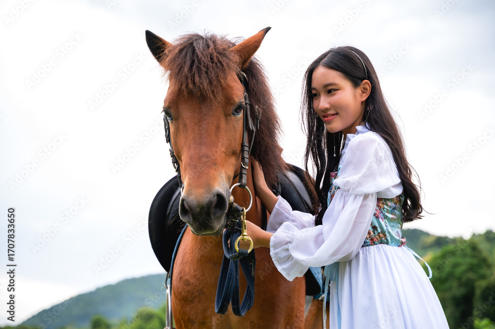 Obraz premium Pretty girl in old fairy tale renaissance costume with white horse in nature
