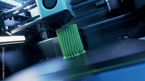 Transforming Green Object Into Reality With 3D Printer in a Modern Workshop Showcasing Detailed Creations in Real-Time