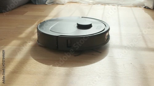 Robot Vacuum Cleaner Navigates Living Room Floor During Afternoon Sunlight