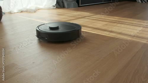 Robot Vacuum Cleaner Navigates Living Room Floor During Afternoon Sunlight