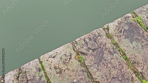 Stone bridge above calm river water