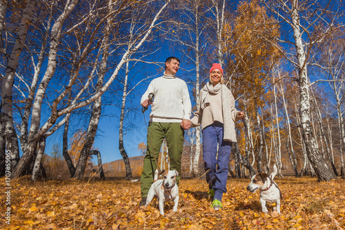 Photography Loving middle aged Couple with dogs in fall park