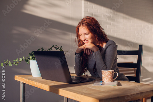 Young woman studying online on laptop at home