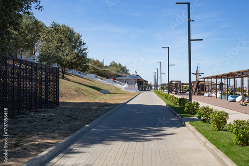 A path made of granite slabs on the Taman Embankment in summer