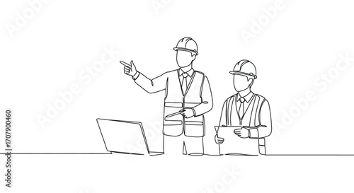 engineers discussing project details using laptop and blueprints